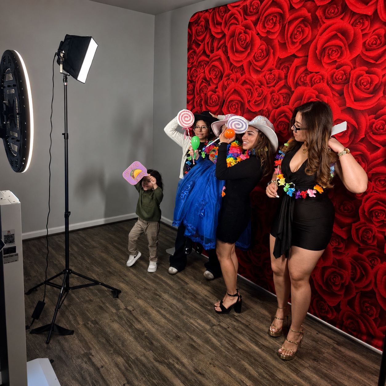Event photo booth rental staged in front of a rose backdrop