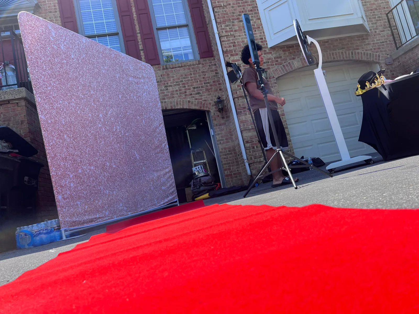 Rose gold backdrop with red carpet driveway setup
